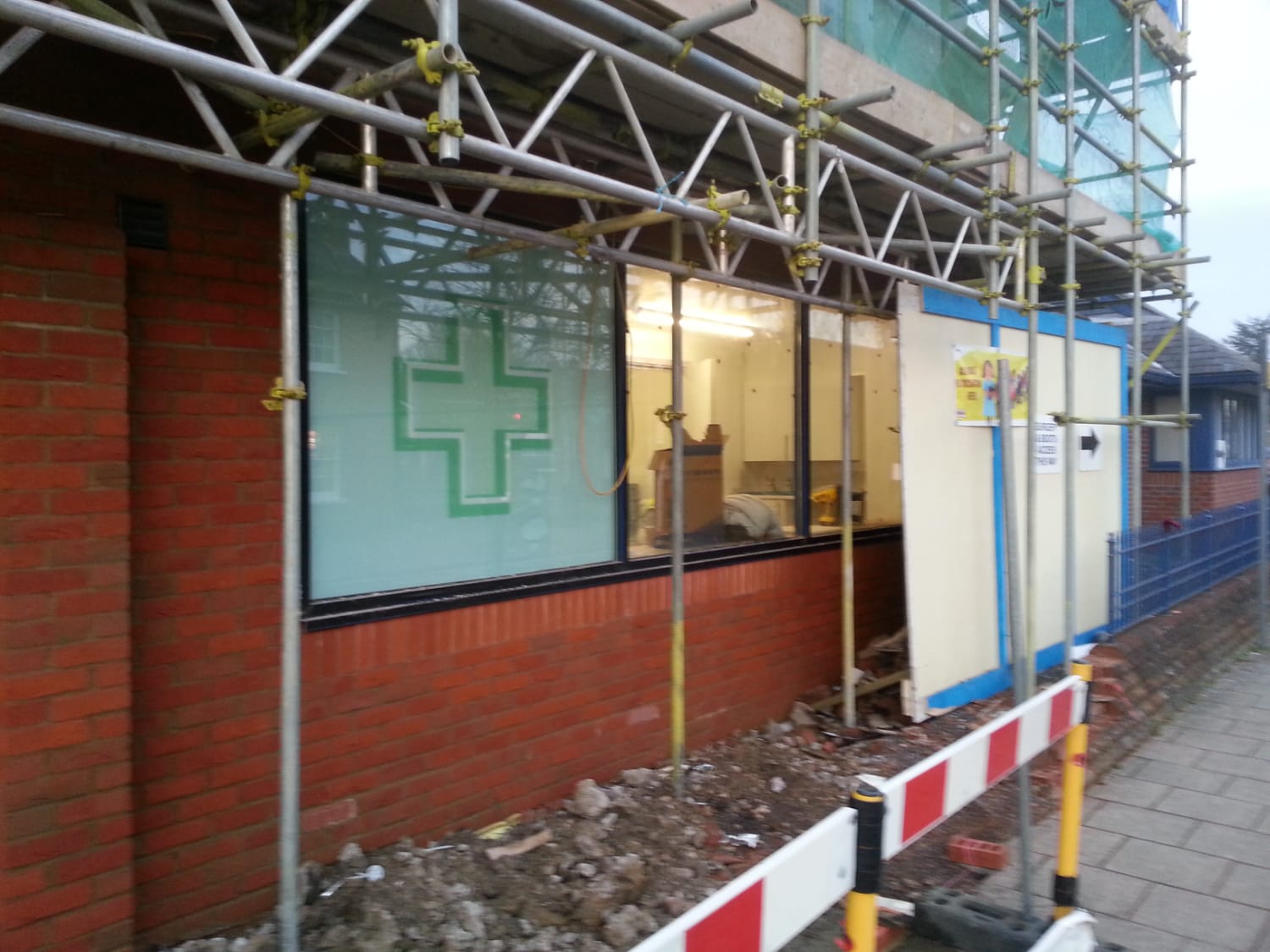 Completed pharmacy development showing ground floor retail unit with residential accommodation above, including external access and frontage improvements.
