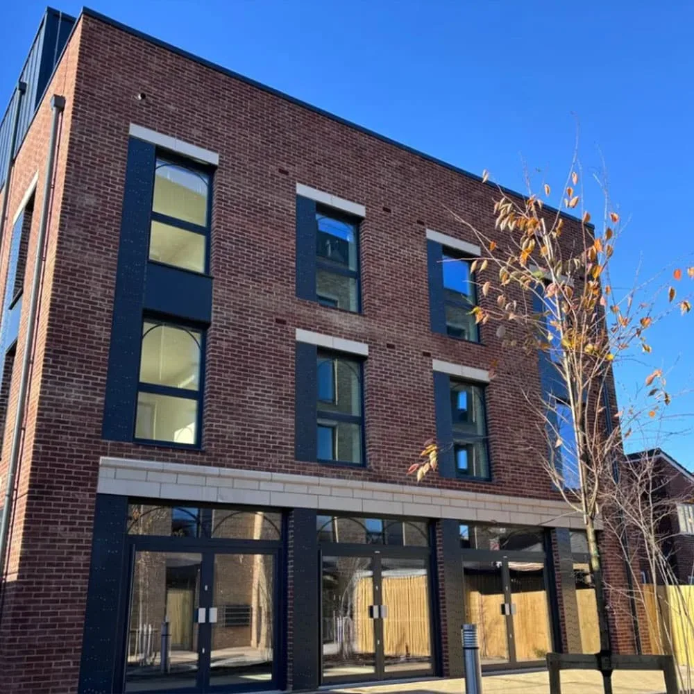 Exterior view of a converted former post office building in Eastleigh, showing a modernised brick façade with new windows and entrance glazing.