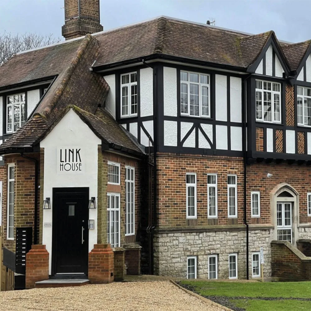 Exterior view of Link House in Southampton, a traditional mock Tudor-style residential building with brickwork, timber framing and main entrance porch