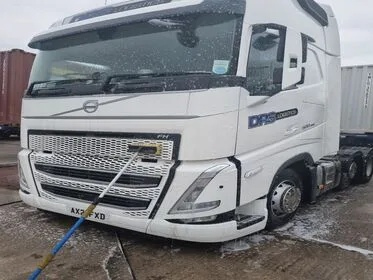 Professional Specialist Truck Washing Volvo articulated lorry undergoing professional specialist cleaning within an industrial yard, illustrating vehicle maintenance and commercial site operations, Eastleigh Hampshire