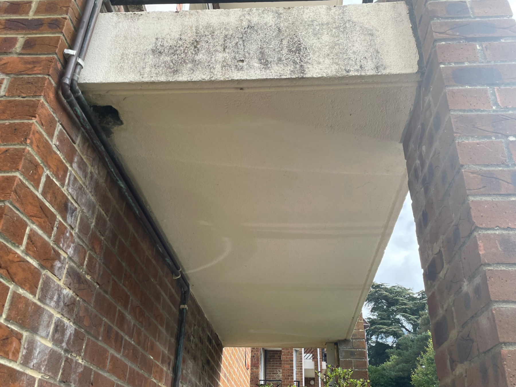 Scaffolded residential block undergoing external maintenance Scaffolded residential block undergoing external maintenance and building repair works, showing access platform and façade improvement works in progress, Poole Dorset