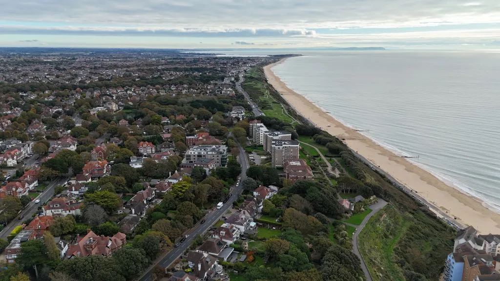 Drone aerial photograph of coastal residential development Drone aerial photograph of coastal residential development and beachfront showing surrounding buildings, shoreline and urban landscape used for property inspection and surveying