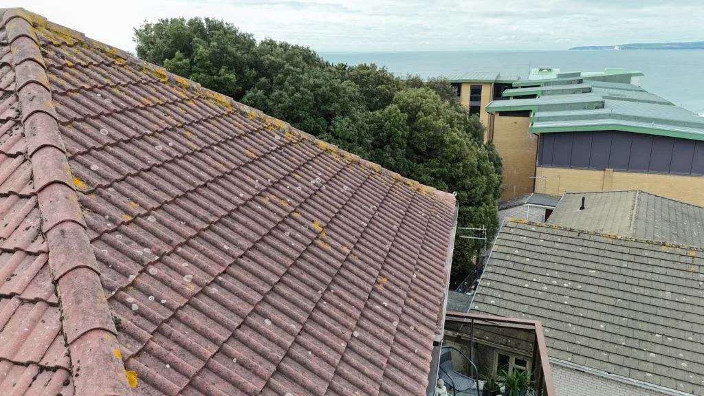 Residential Flat Complex Poole Dorset Drone inspection view of a tiled pitched roof highlighting roof condition and maintenance assessment in Boscombe Dorset