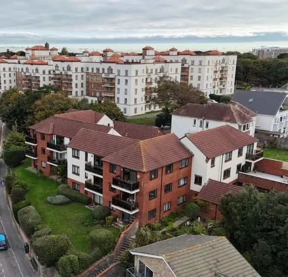 Drone aerial photograph of multi-storey residential apartment block Boscombe Dorset Drone aerial photograph of multi-storey residential apartment blocks and neighbouring housing, showing building layout and external condition within a coastal development Boscombe Dorset