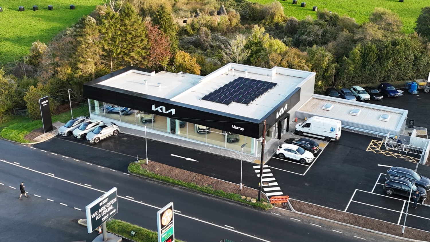 Drone aerial photograph of new Kia Plymouth dealership showcasing completed car showroom and forecourt development