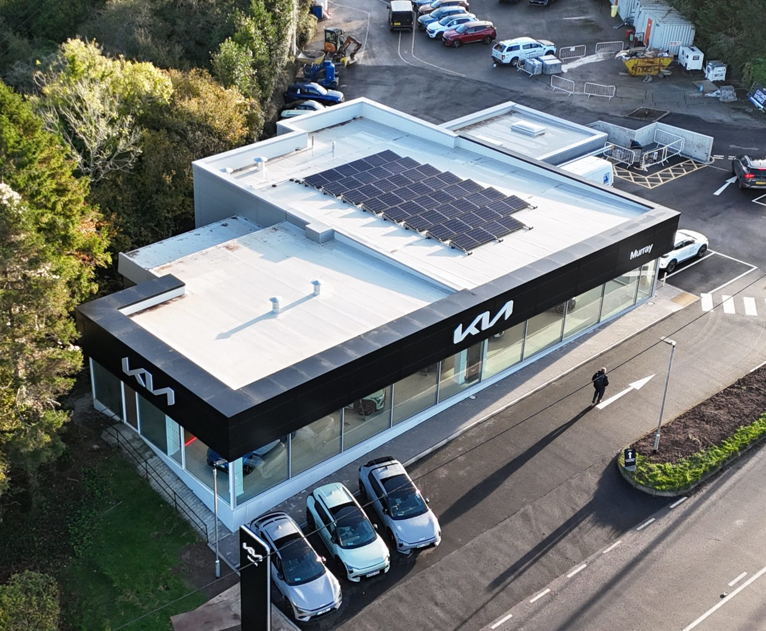 Drone aerial photograph of new Kia Plymouth dealership showcasing completed car showroom and forecourt development