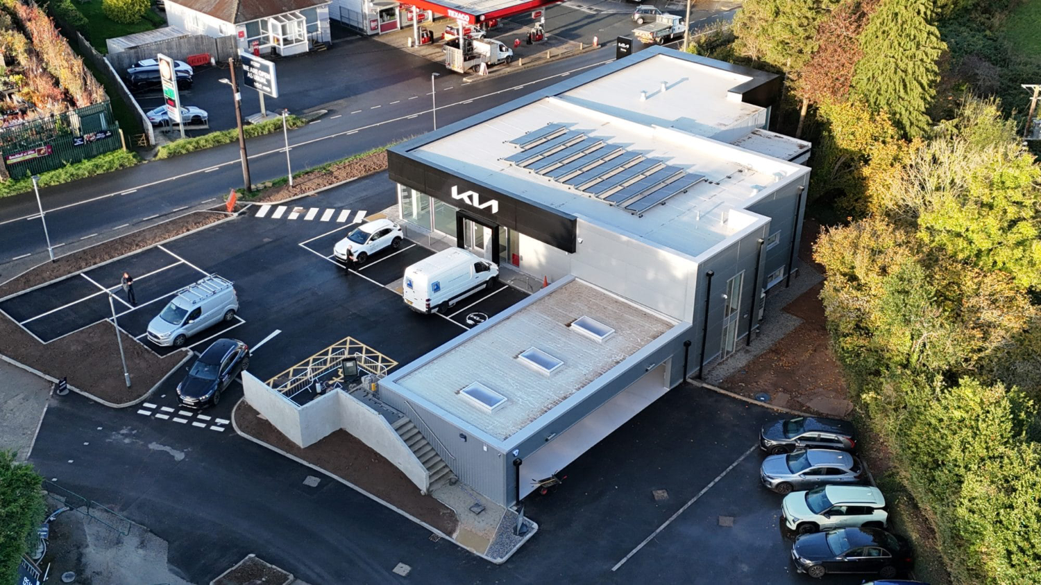 Brand new Kia Dealership Plymouth Drone aerial photograph of new Kia Plymouth dealership showcasing completed car showroom and forecourt development