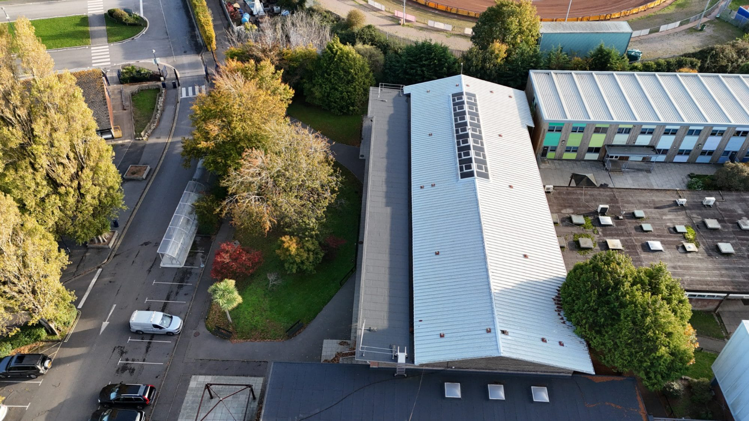 School campus building in Poole Dorset Aerial drone view of school campus building in Poole Dorset and surrounding residential area showing roof layouts and site condition