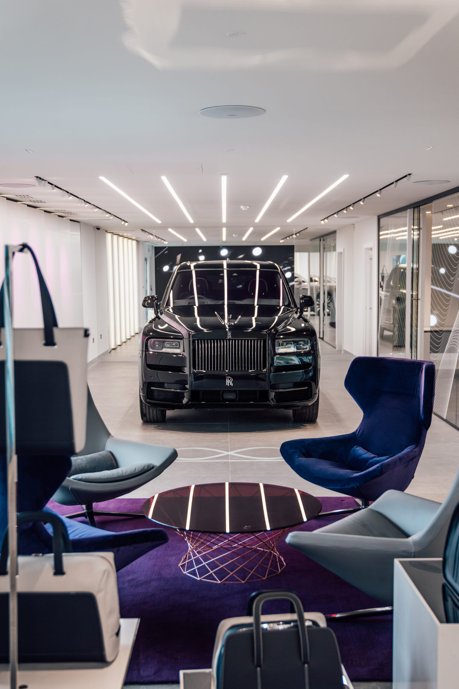 Luxury Rolls-Royce Car modern dealership showroom Luxury Rolls-Royce car displayed inside a modern dealership showroom interior with premium retail fit-out and display area