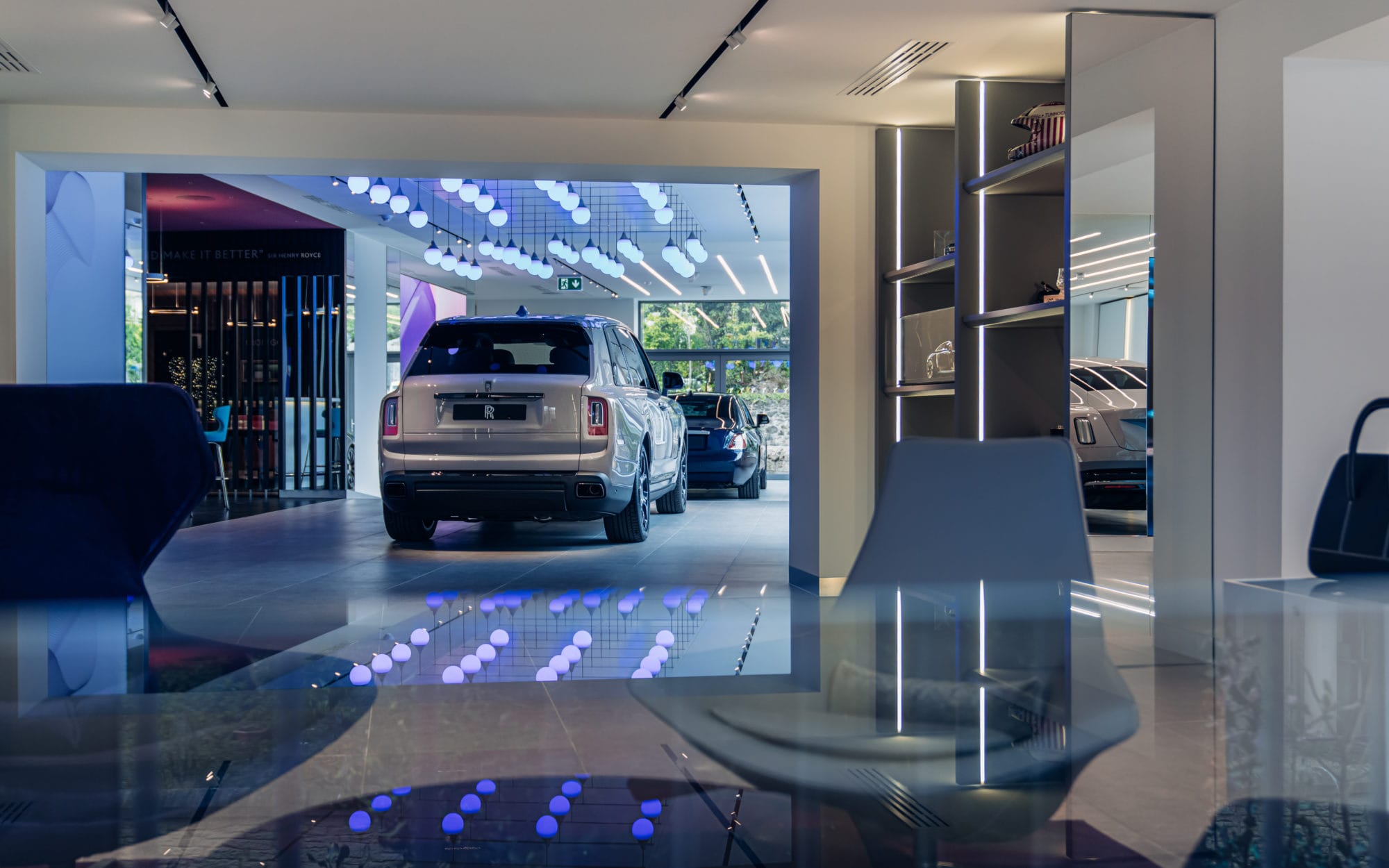 Luxury Rolls-Royce car displayed inside a modern dealership showroom Luxury Rolls-Royce car displayed inside a modern dealership showroom interior with premium retail fit-out and display area